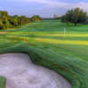 A sunny day view of a hole at Sugar Mill Country Club.