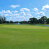 A view of a green with water in background at Pembroke Lakes Golf & Racquet Club.