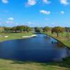 A sunny day view of a hole with water coming into play at Caloosa Golf & Country Club.