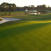 A view of a green with a bunker on the left side at West Course from Plantation Bay Golf and Country Club