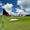 A view of green with clubhouse in background at Oaks Club