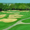 A view of green #14 surrounded by bunkers at Southern Dunes Golf & Country Club