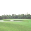 A view of a green guarded by sand trap at Golf Club of the Everglades