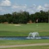 A view of a hole at River Greens Golf Course with water fountain in foreground