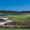 A view of a fairway with water on the left side at Camp Creek Golf Club