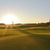 A sunny view of a green at Origins Golf Club