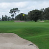 A view of the 18th green protected by bunkers at Miles Grant Country Club