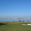 A view of a green with water in background at Belleair Country Club