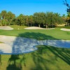 A view of a green protected by a collection of sand traps at Mizner Country Club