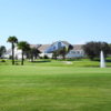 A view of a green and the clubhouse in background at Heritage Pines Country Club