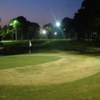 An evening view of a green with water coming into play at Golf Garden