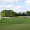 A view of a green with a bridge in background at Colony West Country Club