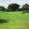 A view of a green guarded by sand traps at Ocean Breeze Golf & Country Club