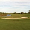 A view of a green protected by an undulating bunker at Medalist Golf Club