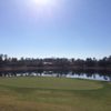 A sunny day view of a green with water in background at DeBary Golf and Country Club