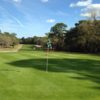 A sunny view of a green at Pine Ridge Golf Club