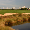 View of a green and clubhouse at The Golf Club at South Hampton