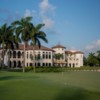 A view of a green and the clubhouse in background at Royal Palm Yacht & Country Club