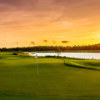 A view of a green with water in background at Esplanade Golf and Country Club of Naples