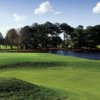 A view of a green with water in background at Countryside Country Club