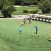 A view of the practice putting green and a tee in the distance at Seven Springs Country Club