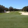 A view of a green protected by tricky sand traps from Club at Hidden Creek