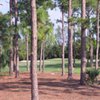 A view of green surrounded by bunkers at Atlantis Country Club