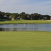 A view of a green with water in background at Green Valley Country Club.