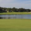 A view of green with water in background at Green Valley Country Club