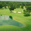 A view of a green with water in background at Wildwood Country Club