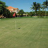 A view of green with clubhouse in left background at Keys Gate Golf Club