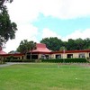 A view of the putting green with clubhouse in background at Country Club of Silver Springs Shores