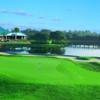 A view of the clubhouse and a green in foreground at University Park Country Club