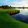 A view of a green with water on the right at University Park Country