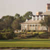 A view of a green and the clubhouse at Old Collier Golf Club.
