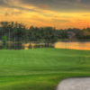A view of a green with water in background at Plantation Bay Golf and Country Club.