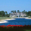 A view from the back of the lake with the 18th hole on the left, the 9th on the right and clubhouse in background at Jacksonville Golf & Country Club