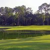 A view of a green with water in foreground at San Jose Country Club