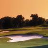 A sunset view of green surrounded by bunkers at Sawgrass Country Club