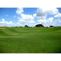 The back nine at Mystic Dunes Golf Club in Celebration, Florida features perimeter mounding and rolling fairways.