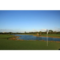 The 17th and 18th holes at Raptor Bay Golf Club wrap around a large pond. 