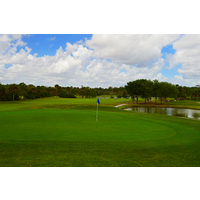 The short par-4 fifth on the Eagle nine at Okeeheelee Golf Course plays to an elevated green around a lake.
